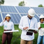 Renewable Energy Jobs in Norway with Visa Sponsorship for Global Applicants african-american-technician-checks-maintenance-solar-panels-group-three-black-engineers-meeting-solar-station (1)