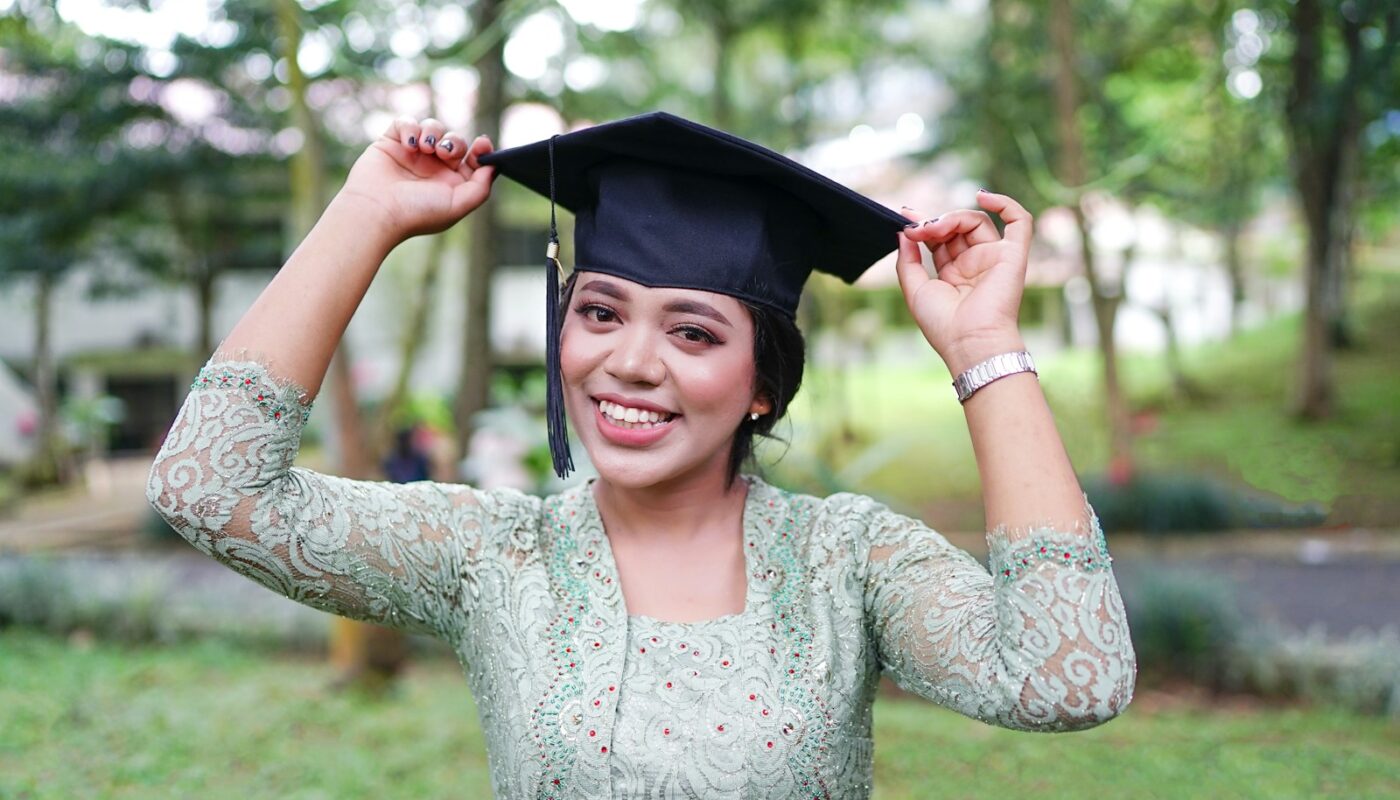 a woman in a graduation cap and gown
